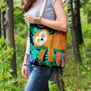 Tote bag azul con oso perezoso anaranjado, hojas tropicales y correas claras de algodón.